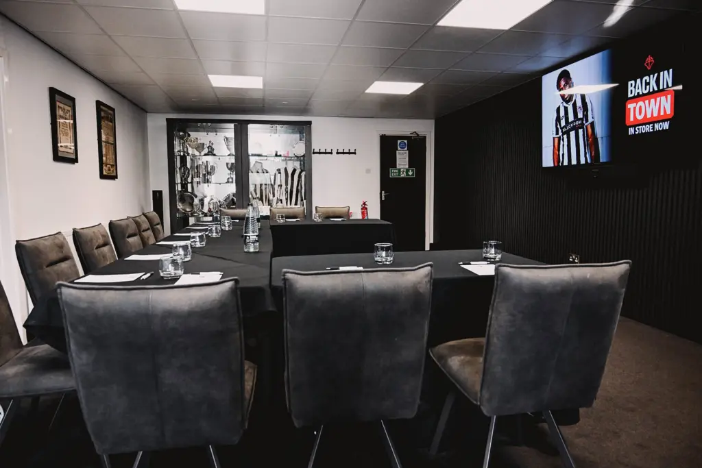 Table set up at McMenemy's Grimsby Town with GTFC merch promotions shown on the TV